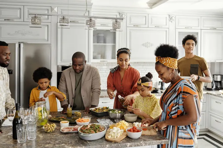 A family cooking together in a kitchen
